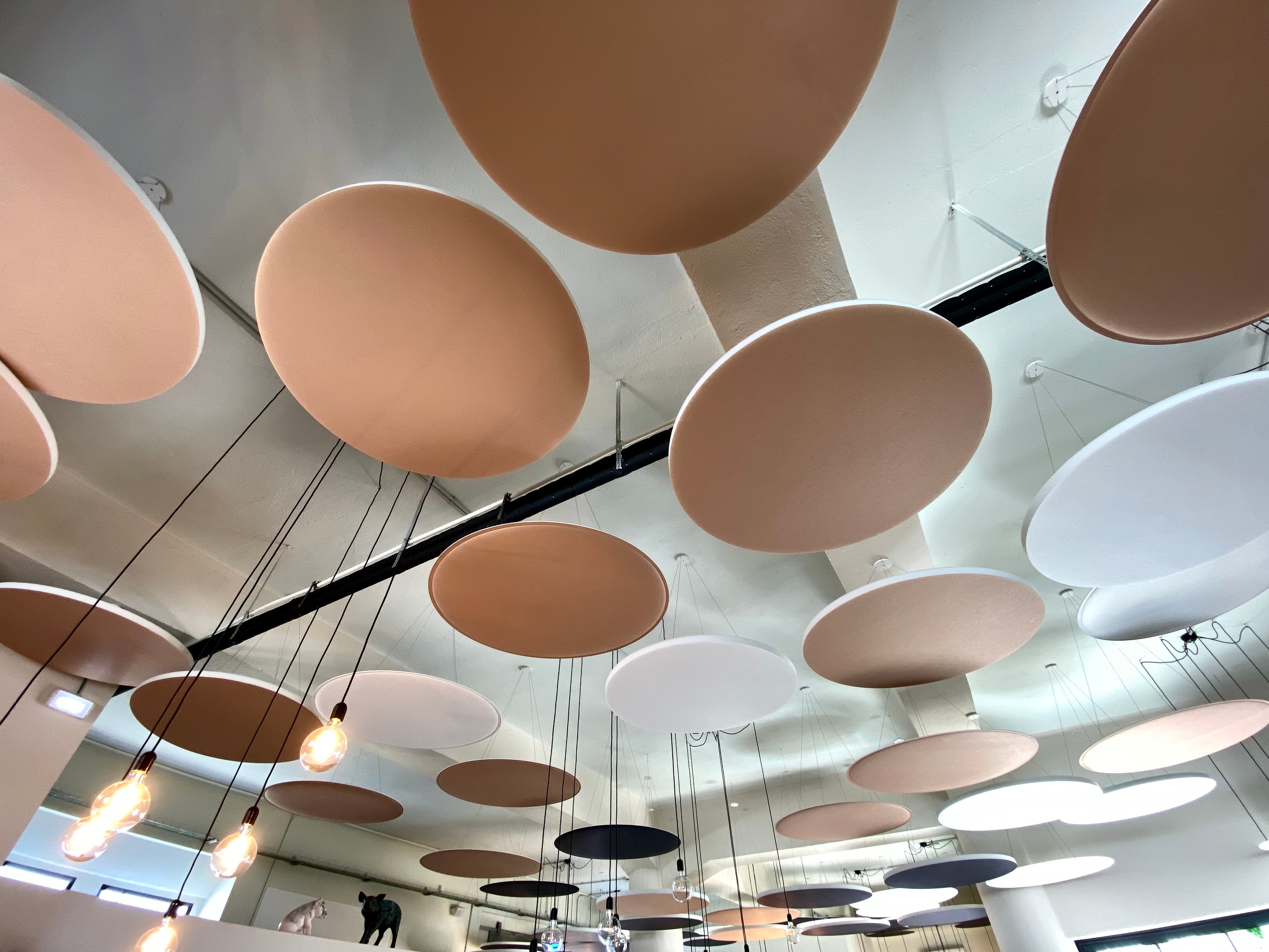 Custom-color ViCloud suspended acoustic panel installed on a restaurant ceiling
